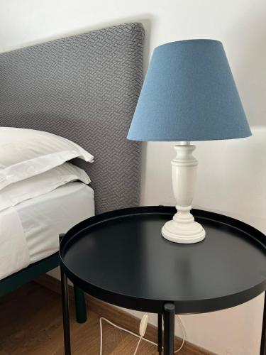 a lamp on a table next to a bed at Charming Navona in Rome