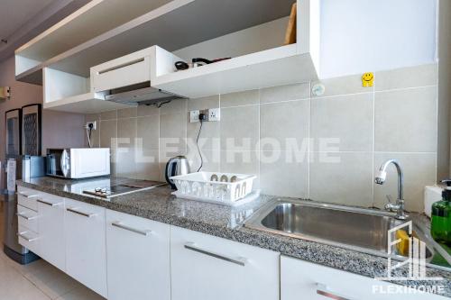 a kitchen with white cabinets and a sink at 10am-6pm, SAME DAY CHECK IN AND CHECK OUT, Work From Home, Shaftsbury-Cyberjaya, Comfy Home by Flexihome-MY in Cyberjaya