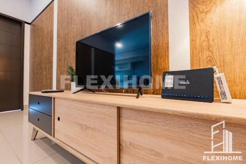 a television on top of a wooden entertainment center at 10am-6pm, SAME DAY CHECK IN AND CHECK OUT, Work From Home, Shaftsbury-Cyberjaya, Comfy Home by Flexihome-MY in Cyberjaya