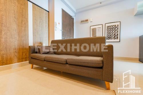 a living room with a brown couch in a room at 10am-6pm, SAME DAY CHECK IN AND CHECK OUT, Work From Home, Shaftsbury-Cyberjaya, Comfy Home by Flexihome-MY in Cyberjaya