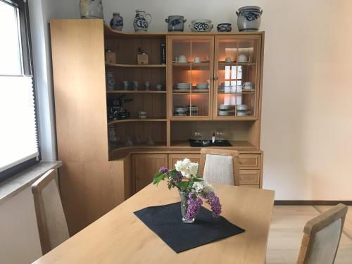 a vase of flowers on a table in a room at Ferienhaus Gerhard in Hornbach