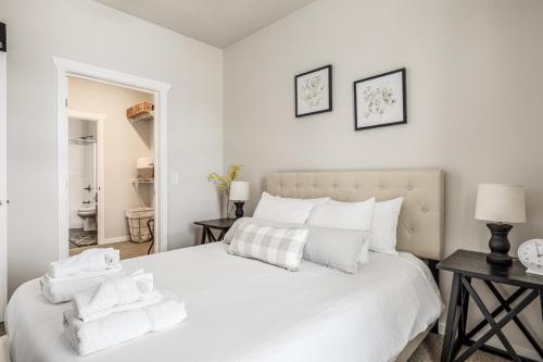 a bedroom with a white bed with towels on it at Adventure Seeker’s Escape Downtown Bikes AC in Traverse City