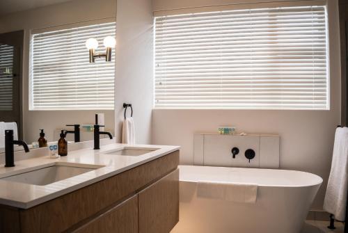 a bathroom with two sinks and a large window at Milk and Honey Villa 192 in Hermanus