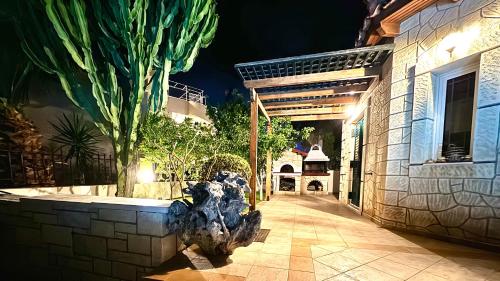 a statue of a dinosaur in front of a building at SeaSide Gem Private Villa Olia with Heated Pool in Kato Gouves
