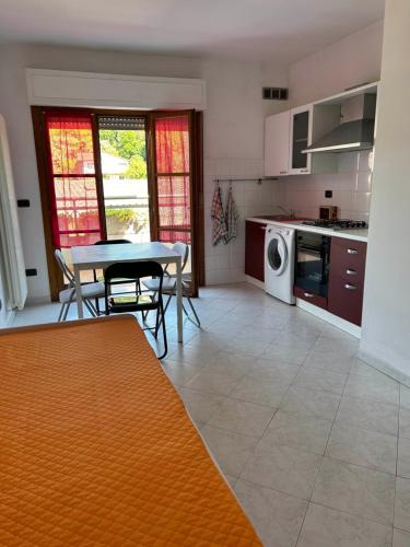 a kitchen with a table and chairs and a table and a stove at Sesta Terra in Aulla