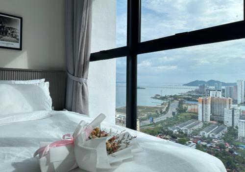 a hotel room with a bed and a large window at DD Condominium 2Bedroom Sea view Georgetown Penang in Jelutong