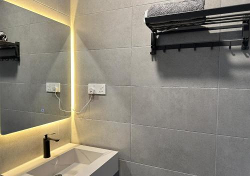 a bathroom with a sink and a mirror at DD Condominium 2Bedroom Sea view Georgetown Penang in Jelutong