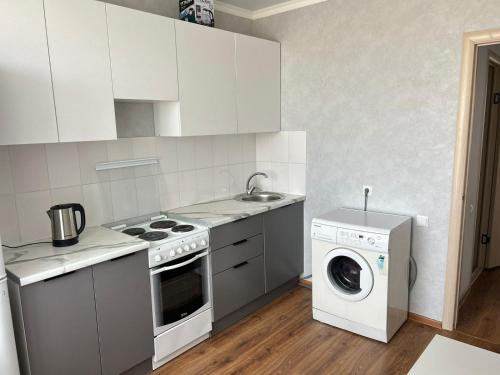 a kitchen with a washing machine and a washer at Абылай хана in Zaozërnyy