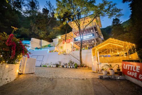 a building is lit up at night with lights at Little Heaven - Cabin 1 in Rājpur