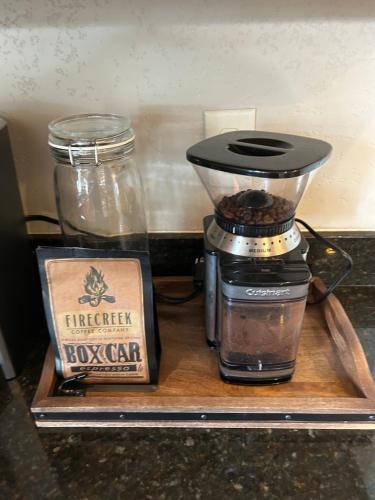 a coffee maker and a box on a wooden tray at Weekly Discount - Cozy Elegant Flagstaff House in Flagstaff