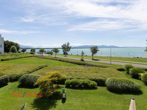 a park with a view of the water at Kaiserstrand Apartment Bodensee - Lake Constance, Lochau - Bregenz, Austria in Lochau