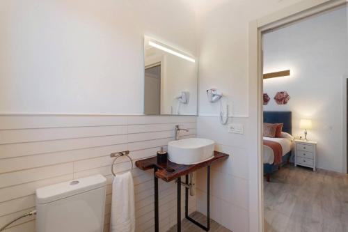 ein weißes Badezimmer mit einem Waschbecken und einem Spiegel in der Unterkunft Comfort apartment Casa Lomo El Aire Acevino with outdoor pool in Tegueste