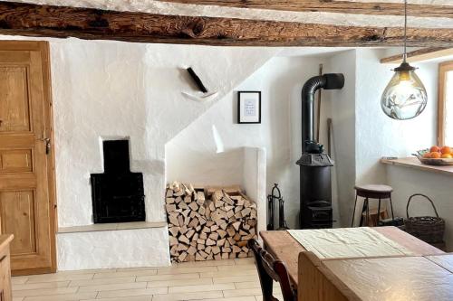 a kitchen with a fireplace and a pile of wood at Spacious 3 bedroom Chalet near Flims in Trin