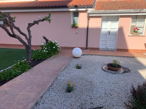 a yard with a house with a white ball in it at Villa Teresa in Oschiri