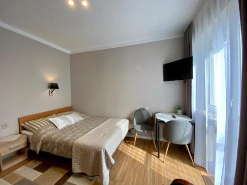 a bedroom with a bed and a table and chairs at Agroturystyka JAGODA in Błonie