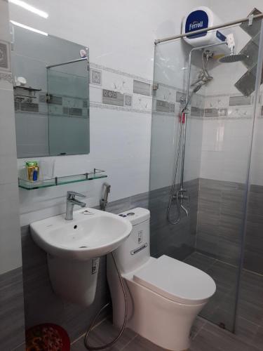 a bathroom with a toilet and a sink and a shower at Anh Đào Dalat House in Da Lat