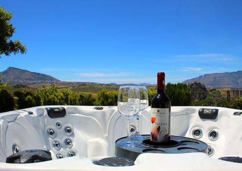 a bottle of wine sitting on a table with a glass at Villa Finestra sul Castello in Partinico