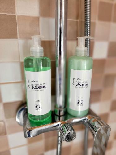 two bottles of soap are sitting on a sink at Casinha da Esquina in Amieira