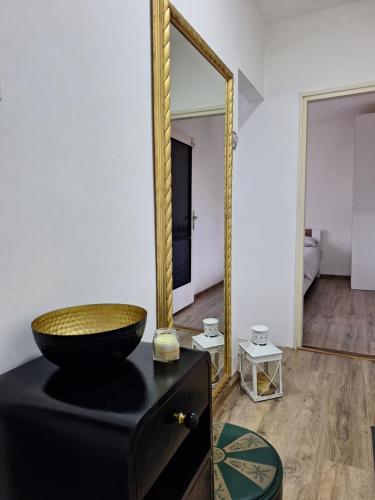 a bathroom with a mirror and a bowl on a dresser at VP in Bajina Bašta
