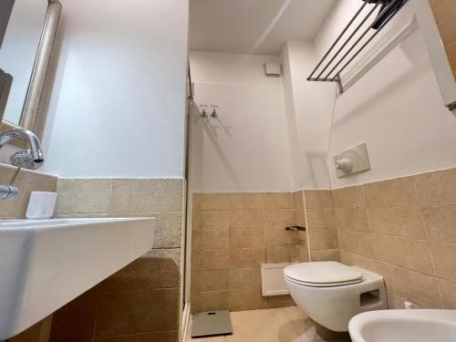 a bathroom with a toilet and a sink at MACA HOUSE in Bari