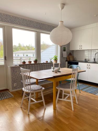 a kitchen with a wooden table and chairs at Ljus och fräsch lägenhet i Ljungskile in Ljungskile