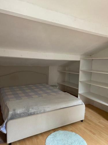 ein weißes Etagenbett in einem Zimmer mit Regalen in der Unterkunft Grande chambre 25m - CLIM in Castelnau-le-Lez