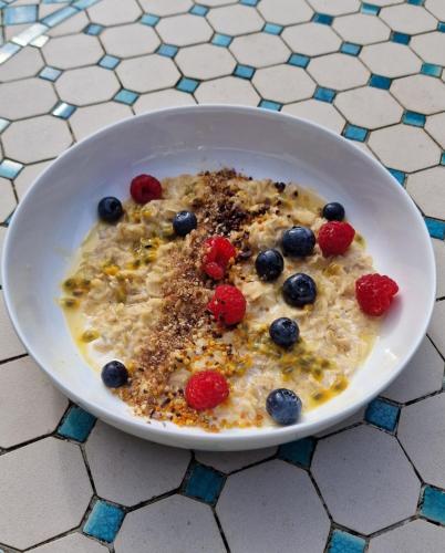 a bowl of oatmeal with berries in it on a table at Mardan House B&B in Killybegs