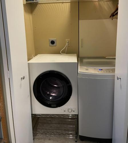 a washer and dryer in a small room at Cozy Beach Front Condo AC Beach Waterfront in Traverse City