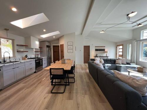 a kitchen and living room with a couch and a table at Cypress House (Historic Coast Guard property) in Point Arena