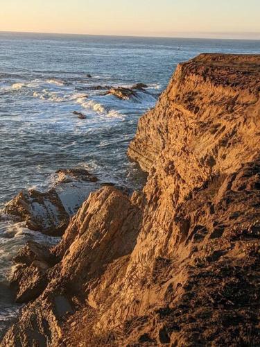 a rocky shoreline with the ocean and the water at Cypress House (Historic Coast Guard property) in Point Arena