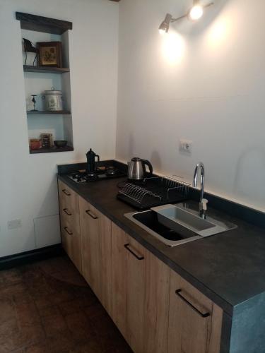 a kitchen with a sink and a counter top at Casetta al Parione in Bolsena