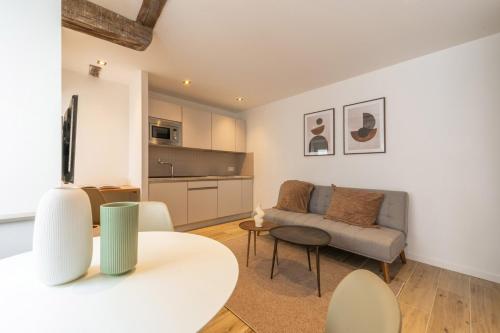 un salon avec un canapé et une table dans l'établissement l'Arsenal - Mulhouse centre historique, à Mulhouse