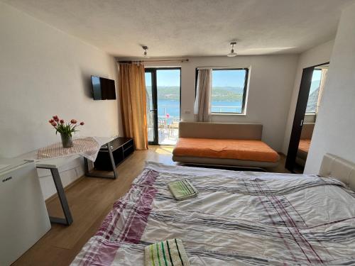 a bedroom with a bed and a view of the ocean at Villa Bellevue in Neum