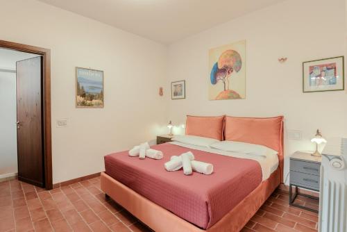 a bedroom with a bed with two stuffed animals on it at Agriturismo Il Mulino delle canutole in Magione