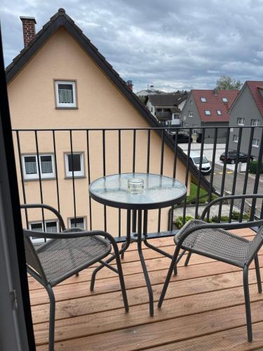 a patio table and two chairs on a balcony at Casa Estella in Rust