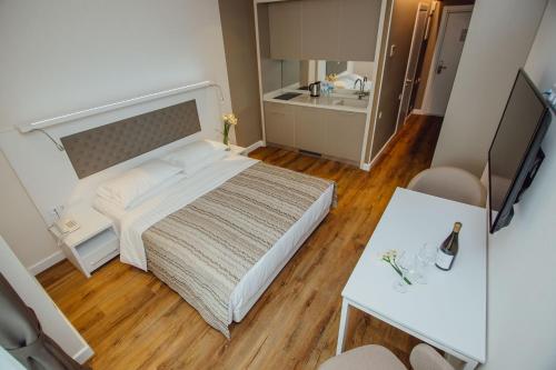 a small bedroom with a bed and a table at My Sunshine Apartments in Batumi in Batumi