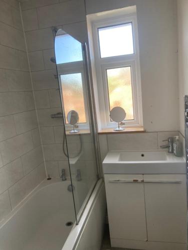 a bathroom with a shower and a sink and a window at Home near Eaton Park near University in Earlham