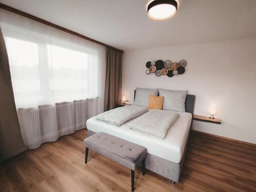 a bedroom with a large bed and a window at Carina's Apartment in Obsteig