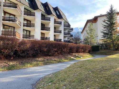 a building with balconies on the side of a road at Appartement au pied des pistes à Chantemerle in Saint-Chaffrey