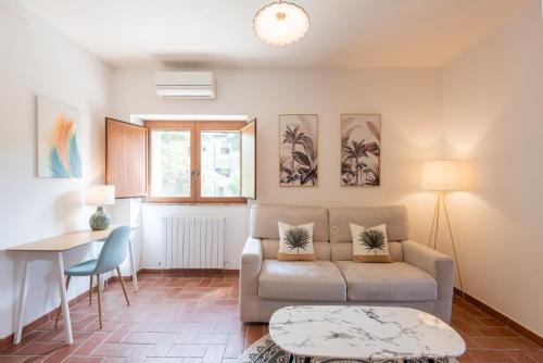 a living room with a couch and a table at Agriturismo Il Mulino delle canutole in Magione