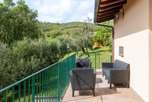 a balcony with chairs and a fence with a view at Agriturismo Il Mulino delle canutole in Magione