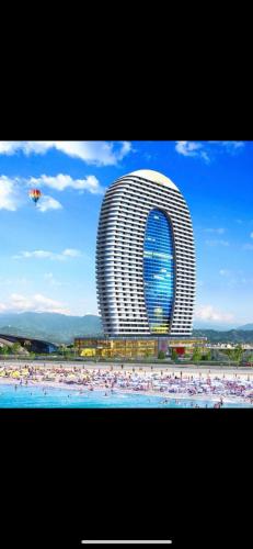 a building with a lot of people in the water at My Sunshine Apartments in Batumi in Batumi