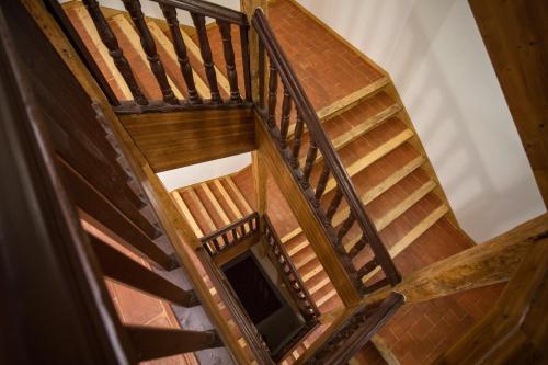 an overhead view of a wooden staircase in a house at El Capricho de Claudia_ Apartamentos Burgos Catedral in Burgos