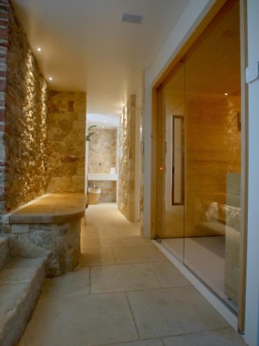 a hallway with a stone wall and a bench at Villa San Liberale - Suites & Wellness - Villa Veneta in Feltre