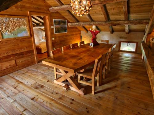 a dining room with a wooden table in a cabin at Villa San Liberale - Suites & Wellness - Villa Veneta in Feltre