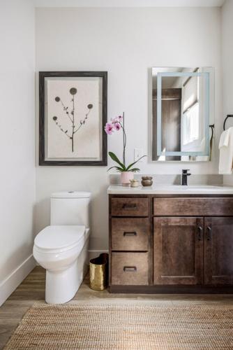a bathroom with a toilet and a sink and a mirror at The Loft on Gillis AC Downtown Beach Rooftop in Traverse City
