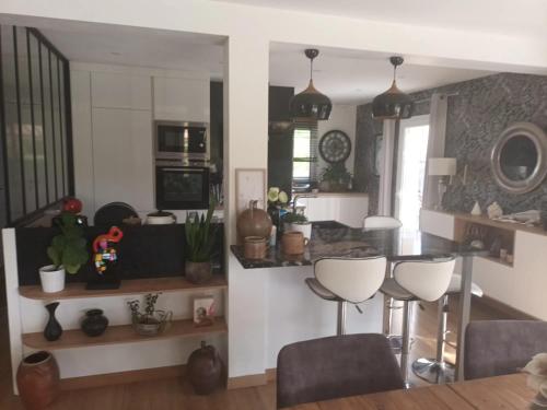 une cuisine avec une table et des chaises dans une pièce dans l'établissement Grande maison familiale et cossue, à Fontaine-Étoupefour