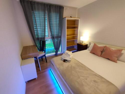 Un dormitorio con una cama con un par de zapatos. en Green Caslano Apartment, en Caslano