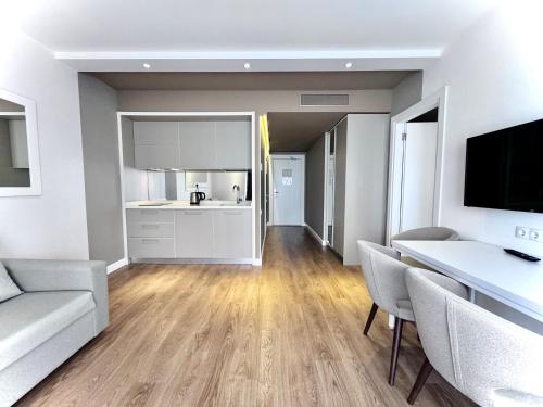 a living room with a couch and a kitchen at My Sunshine Apartments in Batumi in Batumi