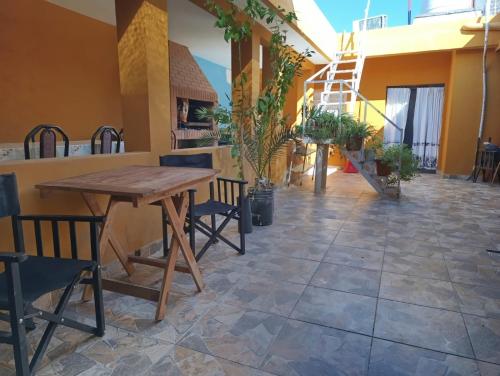 a patio with a wooden table and chairs at Arizona B&P in Termas de Río Hondo